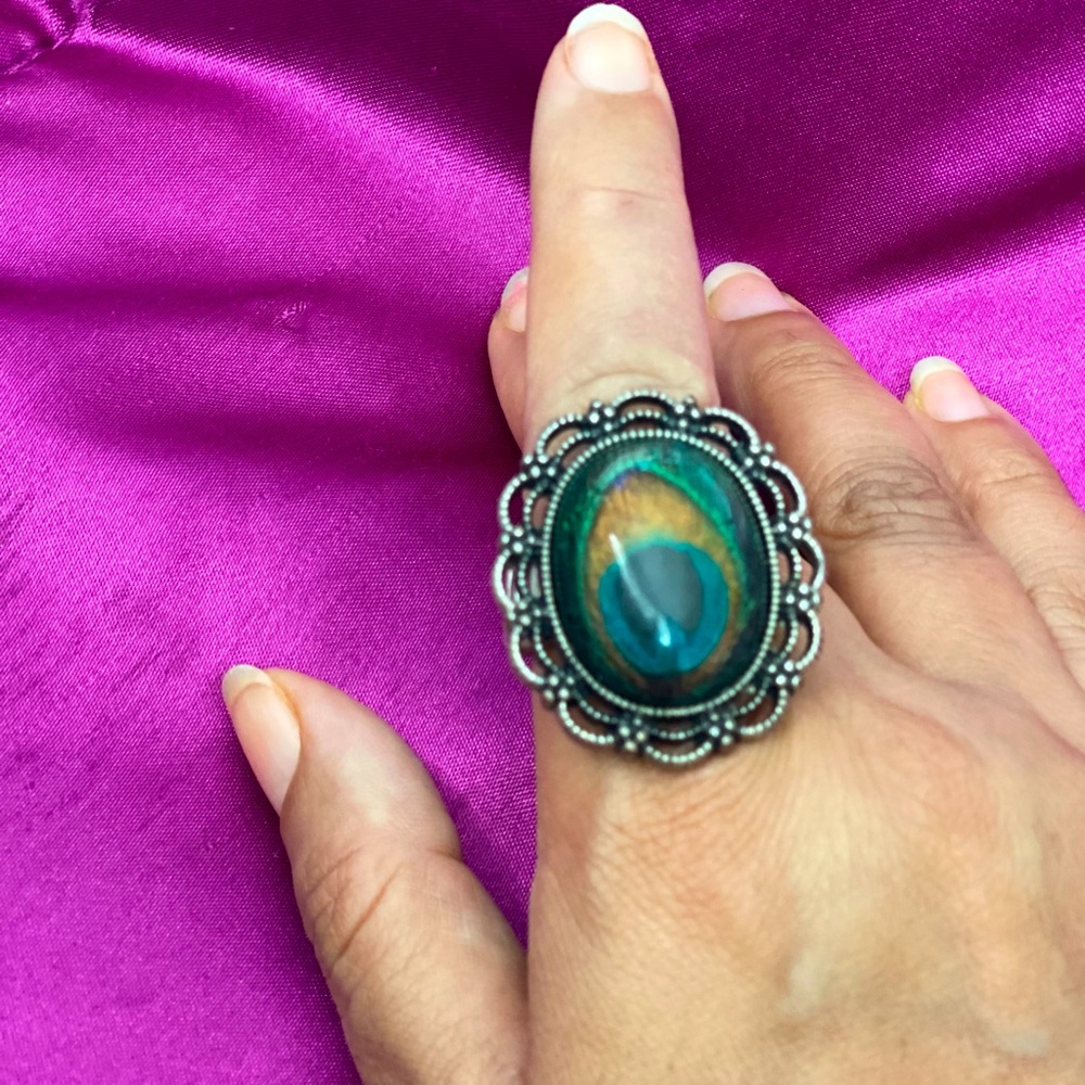 Peacock ring with silver hardware.